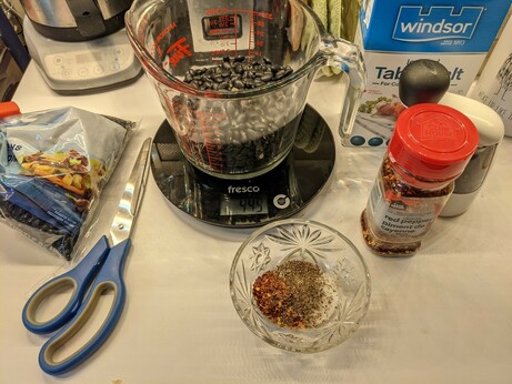 Morning mise en place with dry black beans, red pepper flakes, black pepper, and salt.