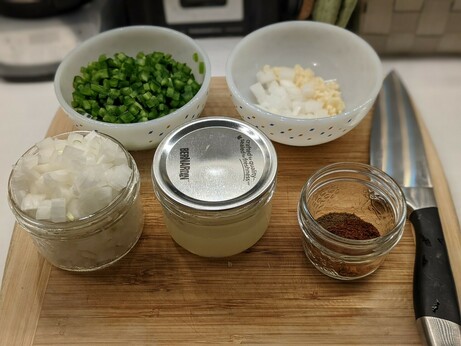 Vegetables now all finely diced into prep bowls, lime juiced into a mason jar, spices portioned into a small glass pot.