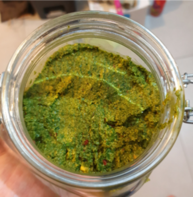 thai pesto in a jar with the light reflecting off the jar